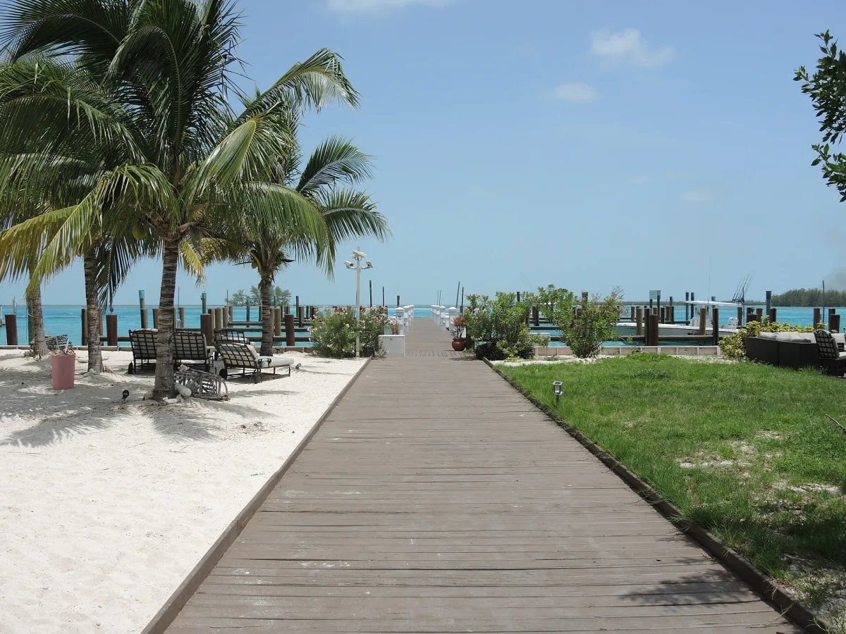 Boardwalk leading to a dock and marina on the turquoise water at Alice Town, North Bimini