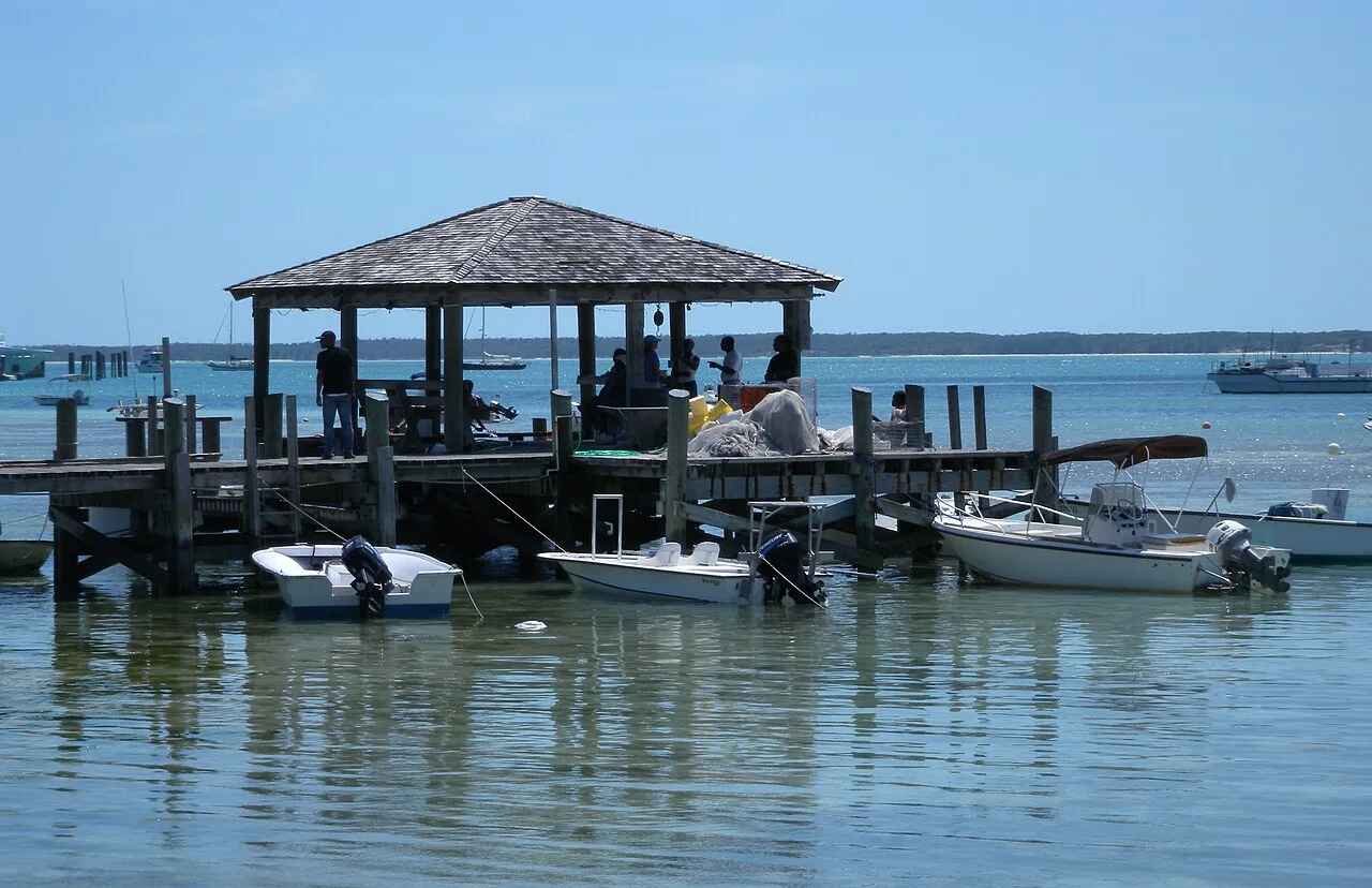 Small open boats moored at a dock on Harbour Island, the type used for water taxi runs to North Eleuthera