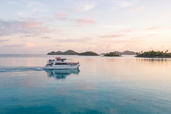 Ferry gliding across perfectly calm turquoise morning sea